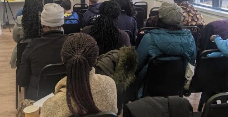 Group of people listening to speaker