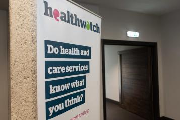 A photo of a Healthwatch banner that reads 'Do health and care services know what you really think?'