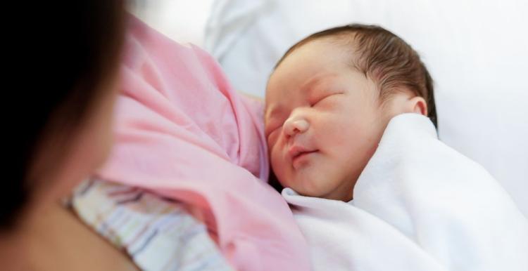 A photograph of mother holding a newborn