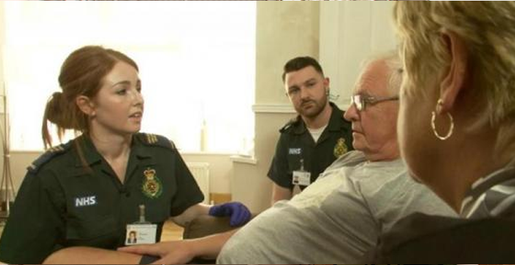 female paramedic talking to and elderly man