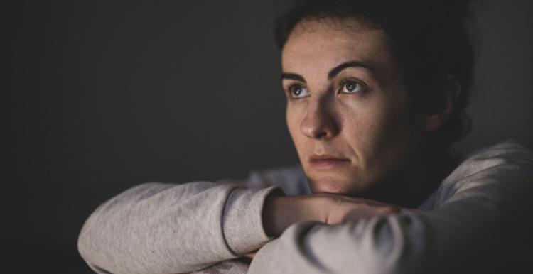 Lady looking ahead with head on arms