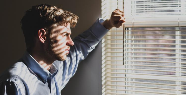 A young man looking out of a window