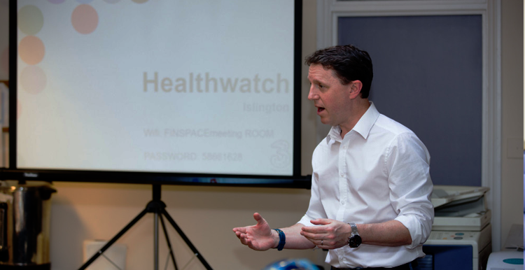 A Healthwatch staff member giving a Powerpoint presentation