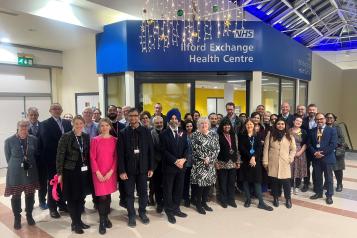 A photo of a group of people stood in front of the new Ilford Exchange Health Centre