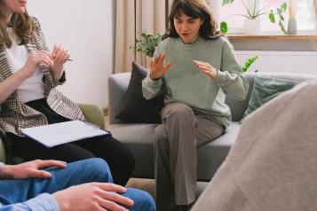 A photo of a group of people speaking with each other