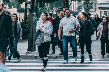 People walking in the street, unmasked