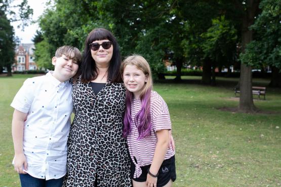 A mother with her son and daughter in a park