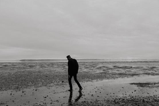 A man walking on an empty beach