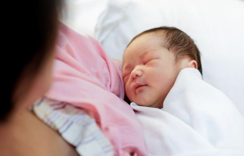 A photograph of mother holding a newborn